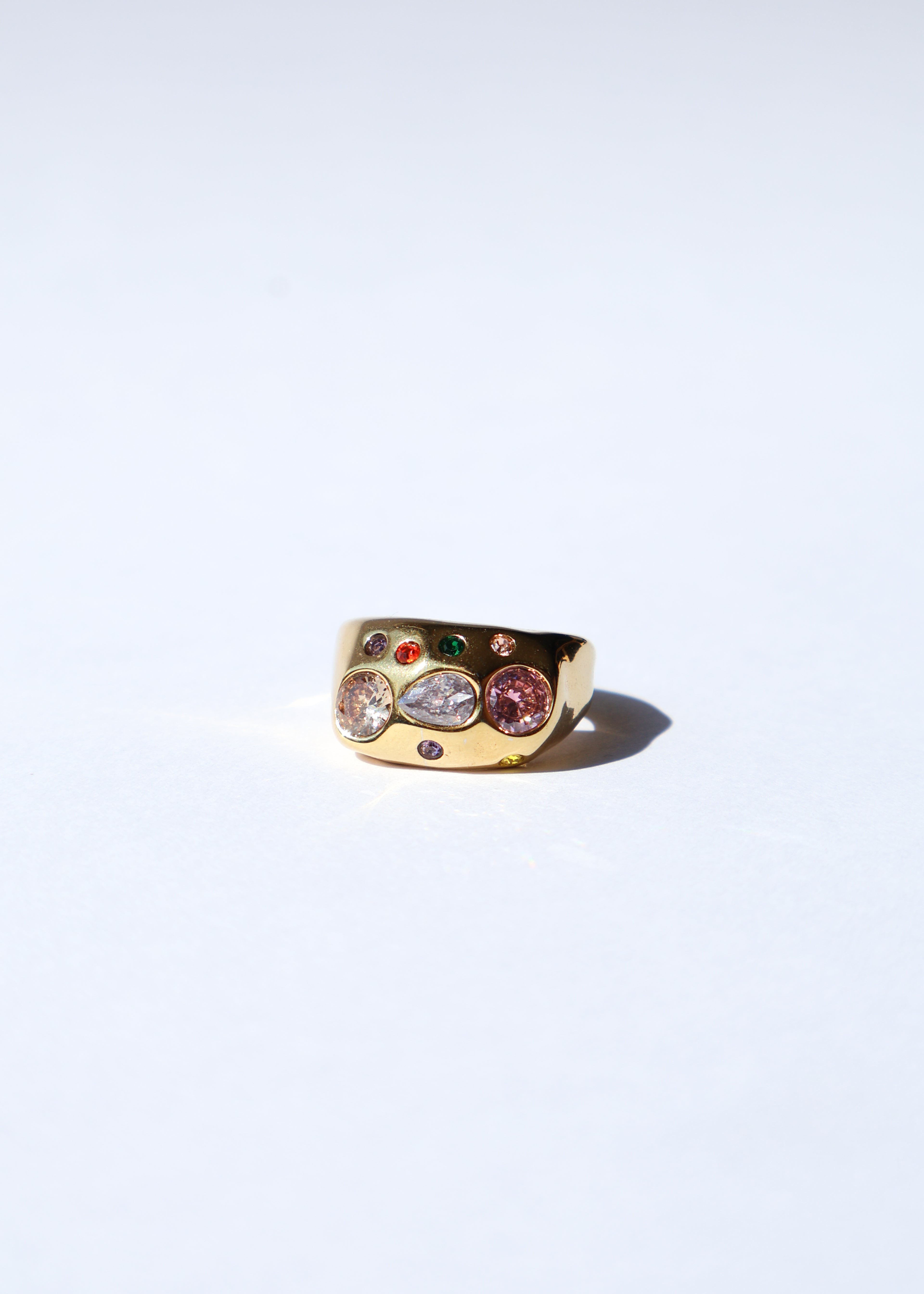 Bague ajustable dorée avec des strass, assez robuste, présentée sur un fond blanc, idéale pour habiller une tenue